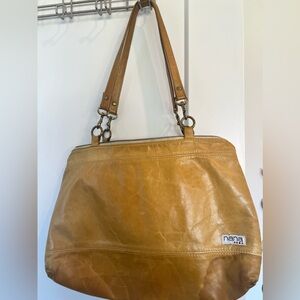 Nana bag, handmade leather bag in mustard with teal triangle on back pocket.